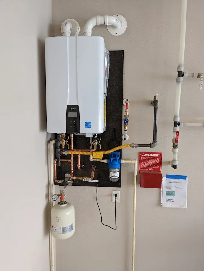 Professional plumber installing copper piping in a Hegins home